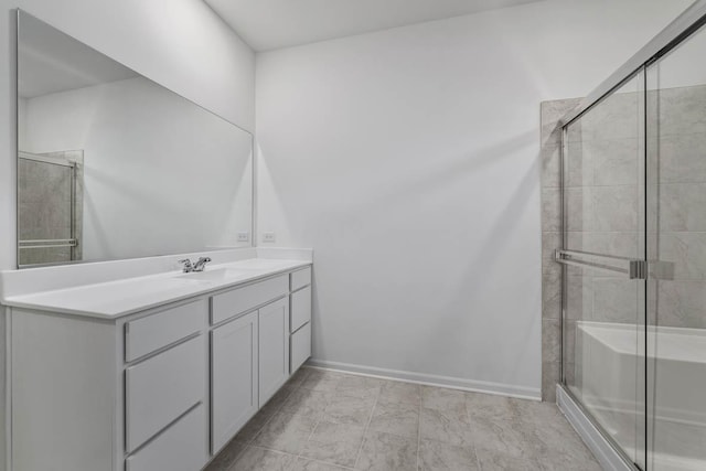 bathroom with vanity and a shower with shower door