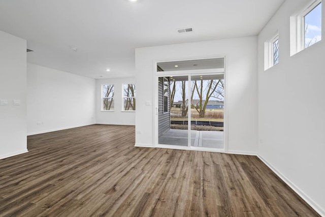 unfurnished living room featuring dark hardwood / wood-style floors