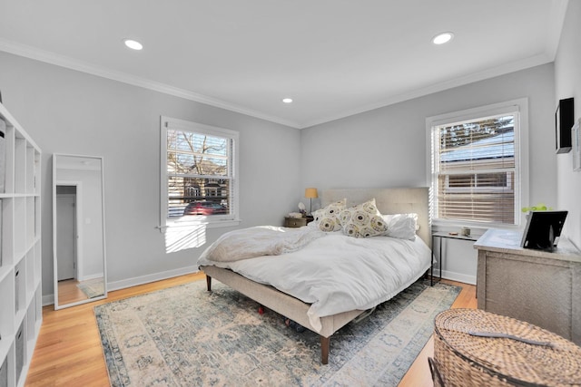 bedroom featuring crown molding and light hardwood / wood-style floors