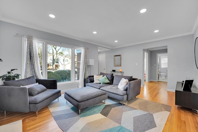 living room with crown molding and light wood-type flooring