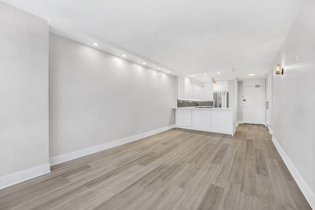 unfurnished living room with light wood-type flooring