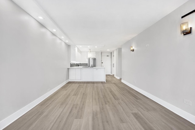 unfurnished living room featuring light hardwood / wood-style floors