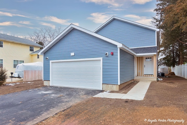 view of front of house featuring central AC unit and a garage