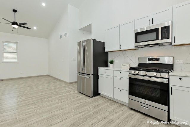 kitchen featuring white cabinets, decorative backsplash, and stainless steel appliances