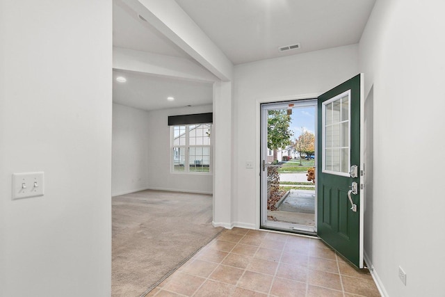 view of carpeted entrance foyer