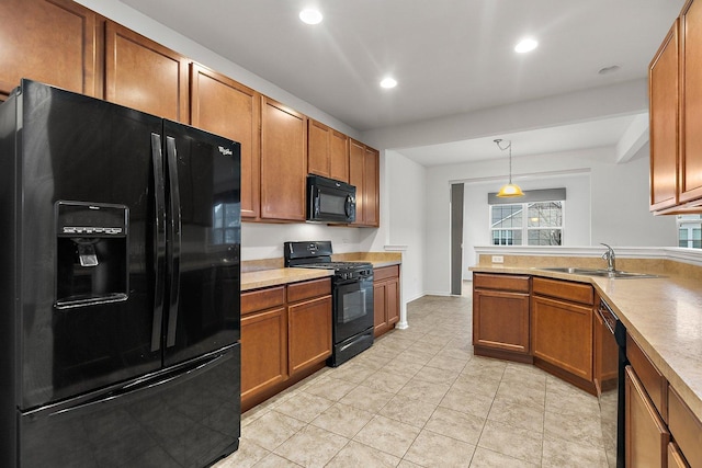 kitchen with light tile patterned flooring, pendant lighting, sink, and black appliances