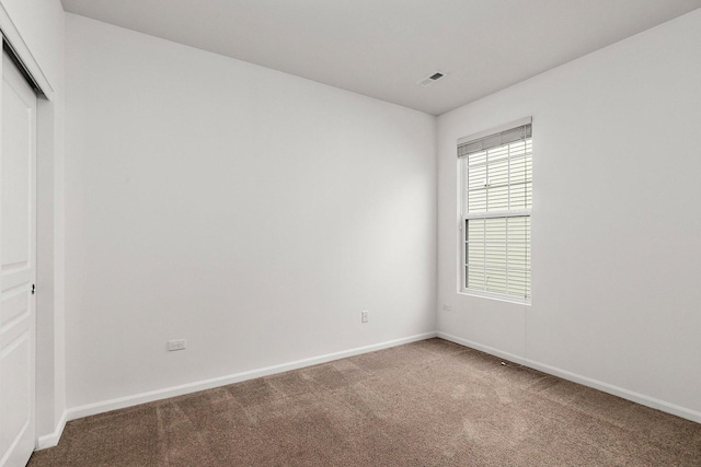 unfurnished room with carpet flooring