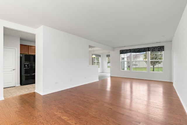 unfurnished living room with light wood-type flooring