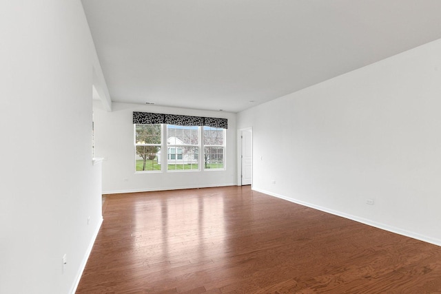 empty room featuring dark wood-type flooring