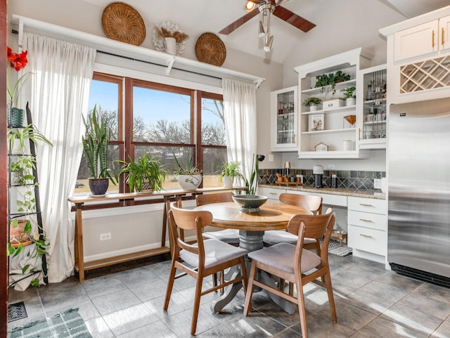 dining room with vaulted ceiling and ceiling fan