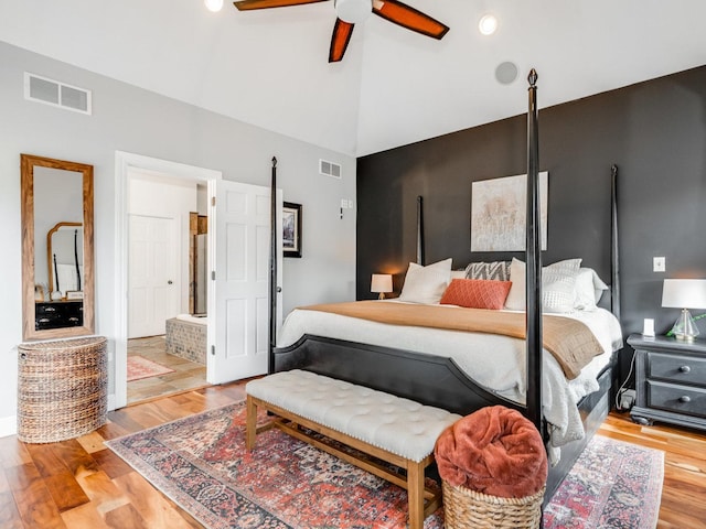 bedroom with high vaulted ceiling, hardwood / wood-style floors, and ceiling fan