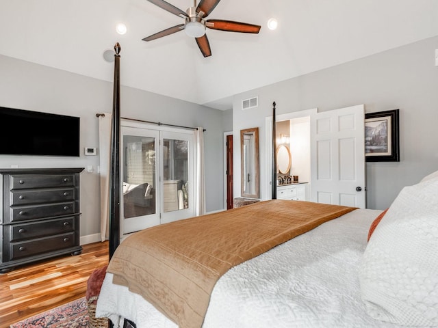 bedroom with ceiling fan, visible vents, wood finished floors, high vaulted ceiling, and ensuite bath
