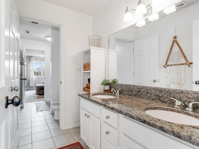 bathroom with vanity, tile patterned floors, and toilet