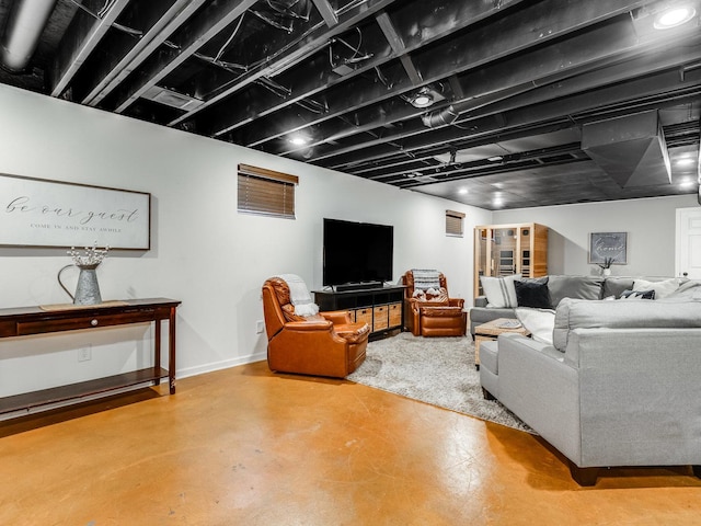 living room with baseboards, visible vents, and finished concrete floors