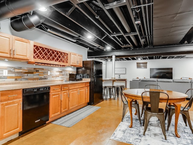 kitchen featuring sink, decorative backsplash, and black appliances