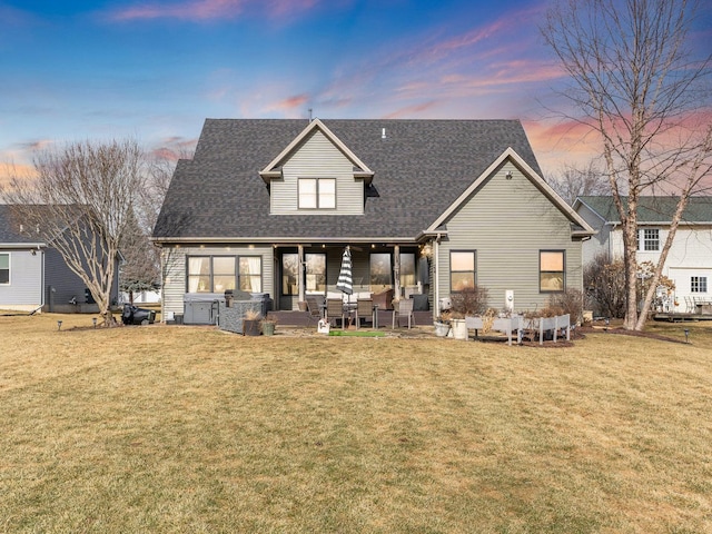 back of property featuring a yard, a patio, outdoor lounge area, and roof with shingles