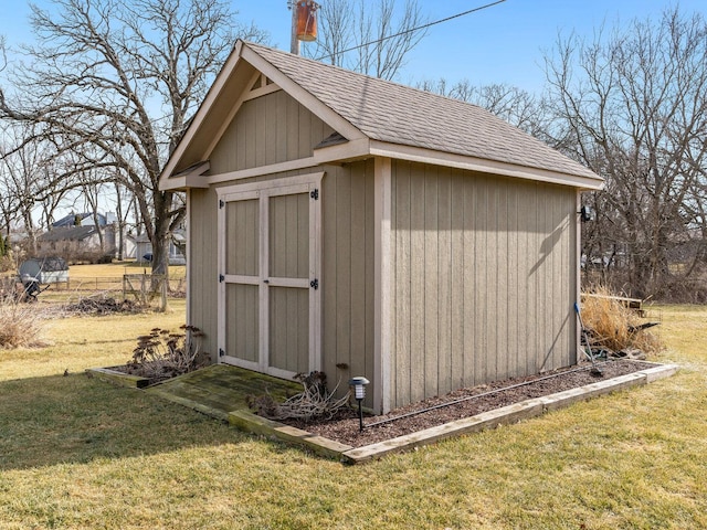 view of outbuilding featuring a lawn