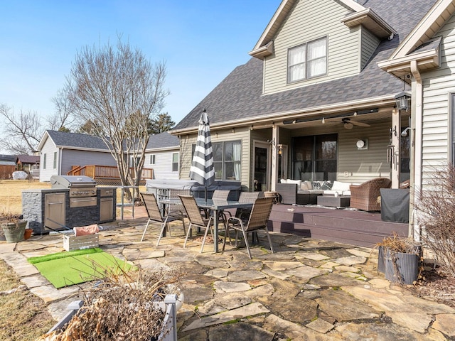 view of patio featuring area for grilling, ceiling fan, and outdoor lounge area