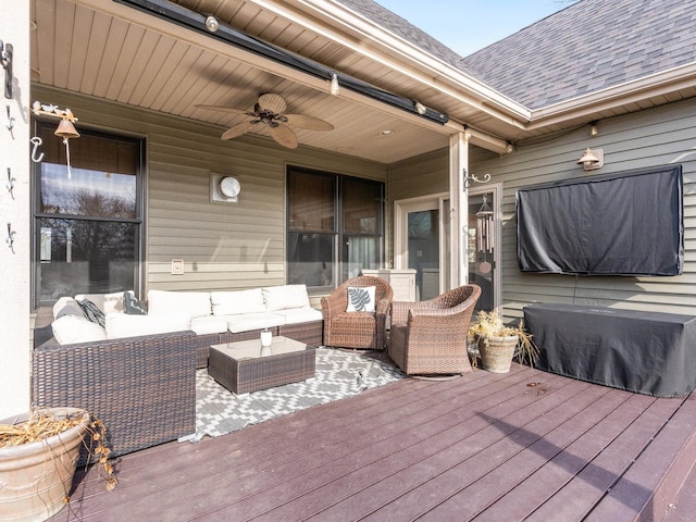 wooden deck with an outdoor living space and a ceiling fan
