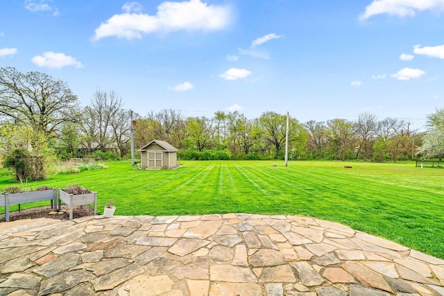 view of patio / terrace with an outdoor structure and a shed