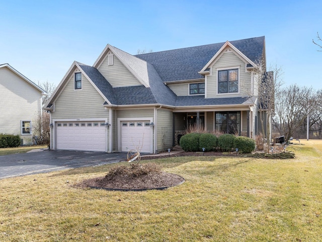 view of front of house with a garage, a porch, and a front yard