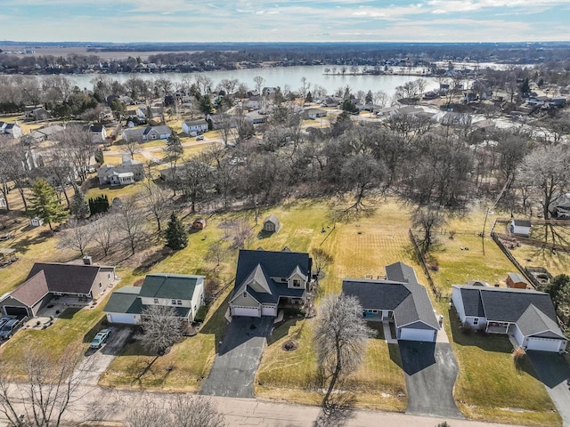 birds eye view of property with a water view and a residential view