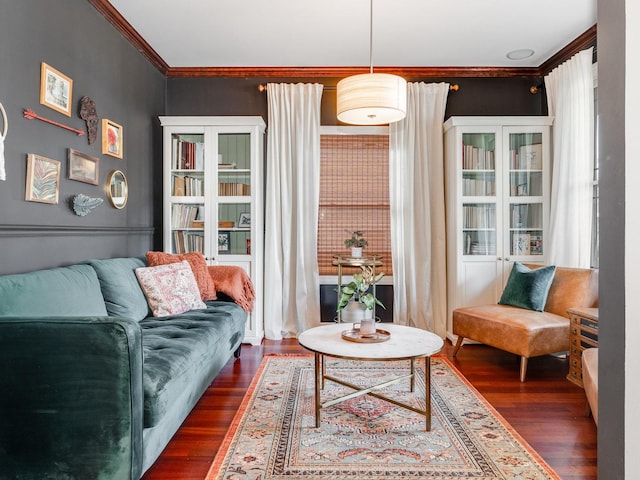 living area featuring ornamental molding and dark hardwood / wood-style flooring