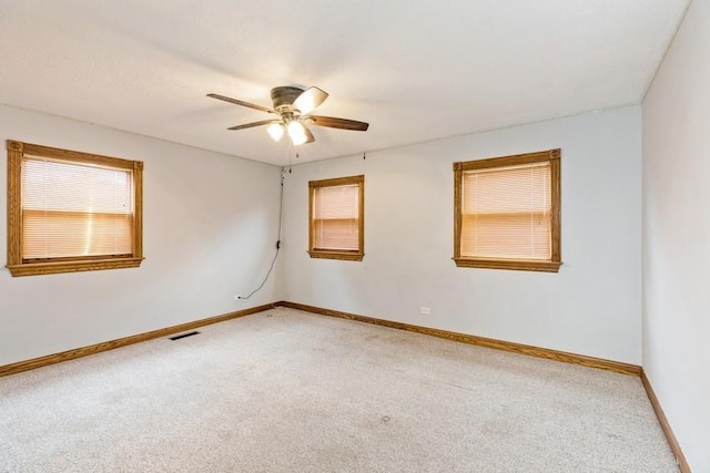 carpeted empty room featuring ceiling fan