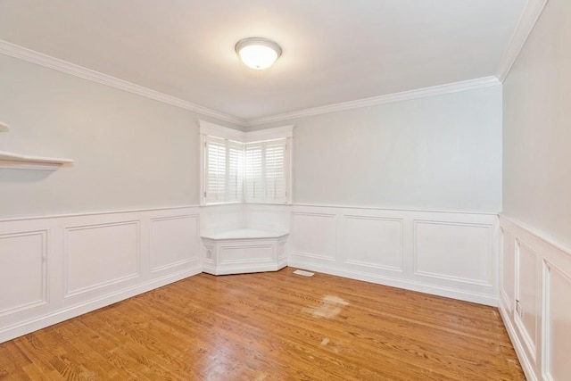 unfurnished room featuring crown molding and light hardwood / wood-style flooring