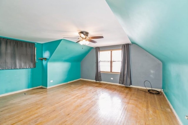 bonus room with ceiling fan, light hardwood / wood-style floors, and vaulted ceiling