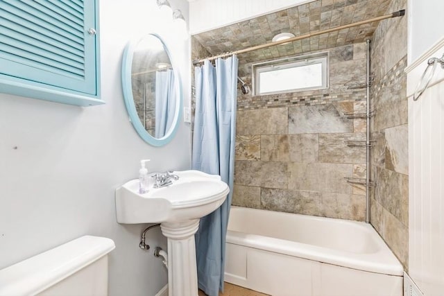 bathroom featuring shower / bath combo and toilet