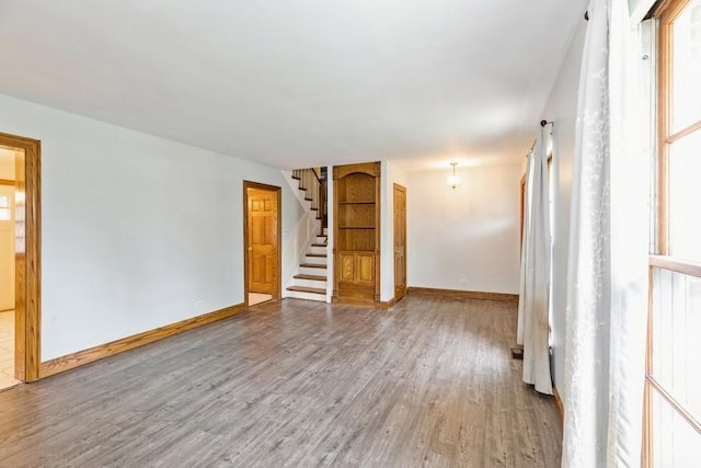 unfurnished room with wood-type flooring