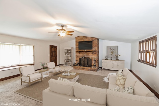 living room featuring ceiling fan, carpet floors, a fireplace, and vaulted ceiling