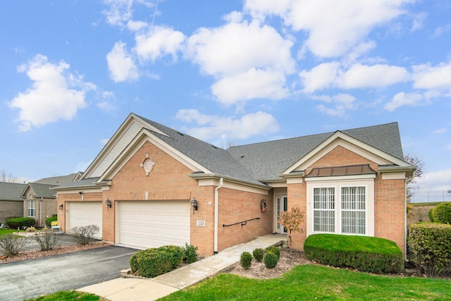 view of front of house with a garage and a front lawn