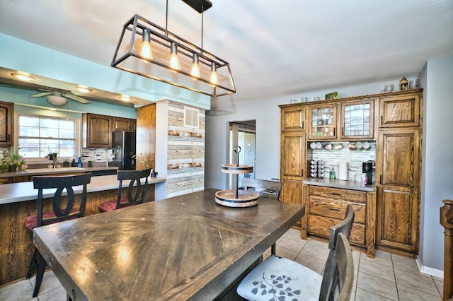 dining room featuring light tile patterned floors and ceiling fan