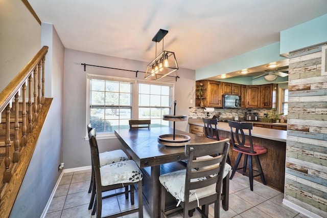 dining space with ceiling fan and light tile patterned floors