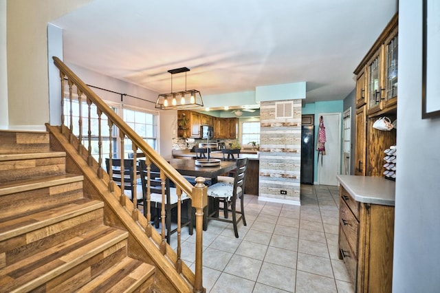 kitchen featuring pendant lighting, light tile patterned floors, and tasteful backsplash