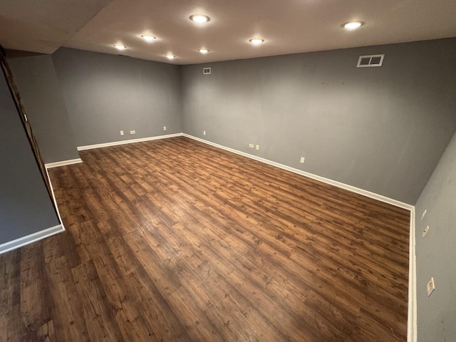 basement with dark hardwood / wood-style floors