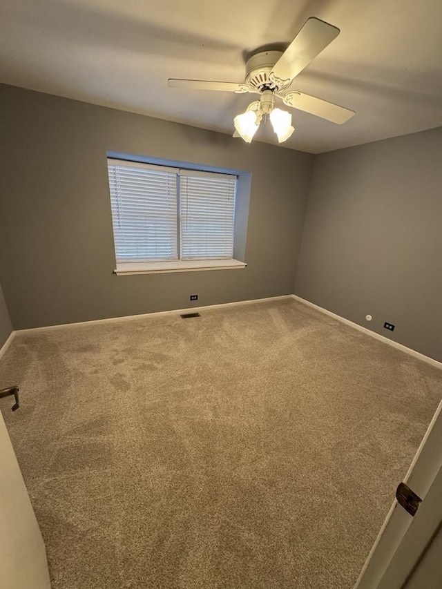 carpeted empty room with ceiling fan