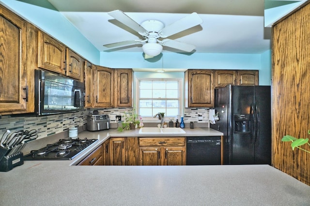 kitchen with black appliances, backsplash, ceiling fan, and sink