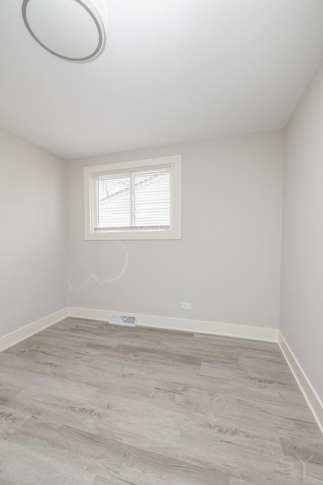 unfurnished room with light wood-type flooring