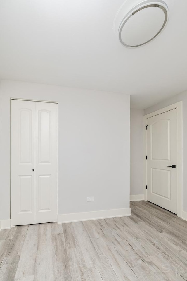 empty room with light hardwood / wood-style flooring