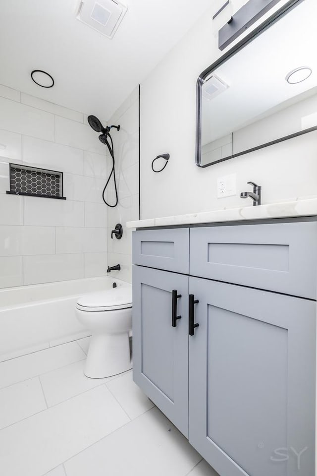 full bathroom with tile patterned flooring, vanity, toilet, and tiled shower / bath combo