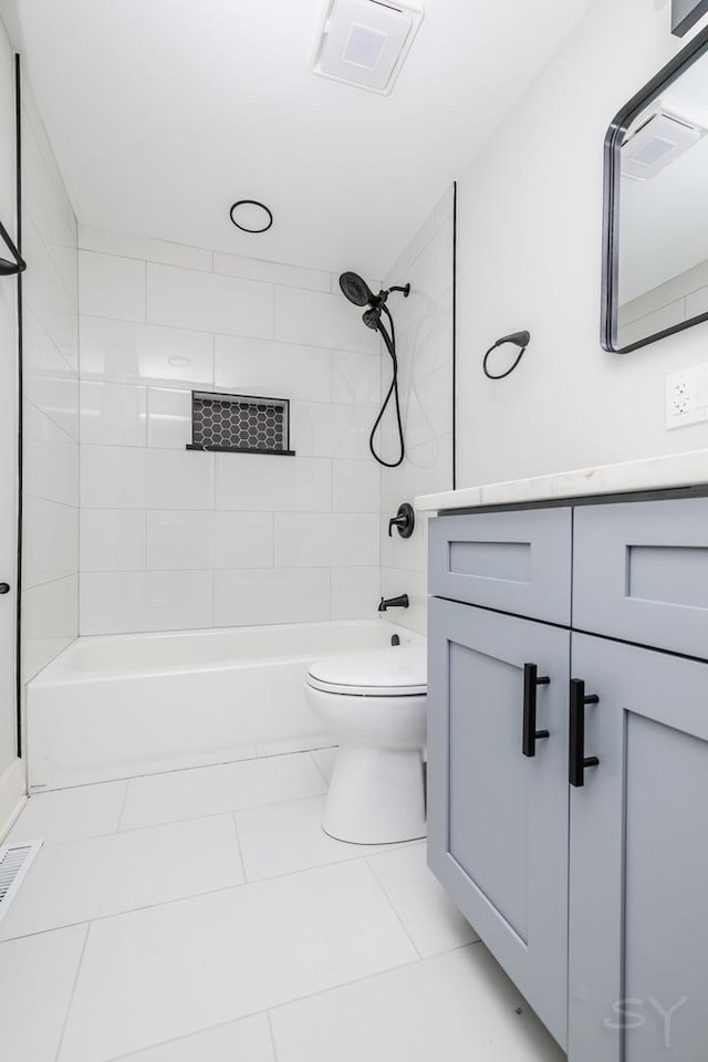 full bathroom with tile patterned flooring, vanity, toilet, and tiled shower / bath combo