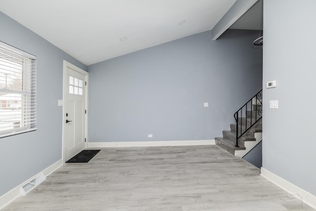 entryway with light hardwood / wood-style flooring and lofted ceiling