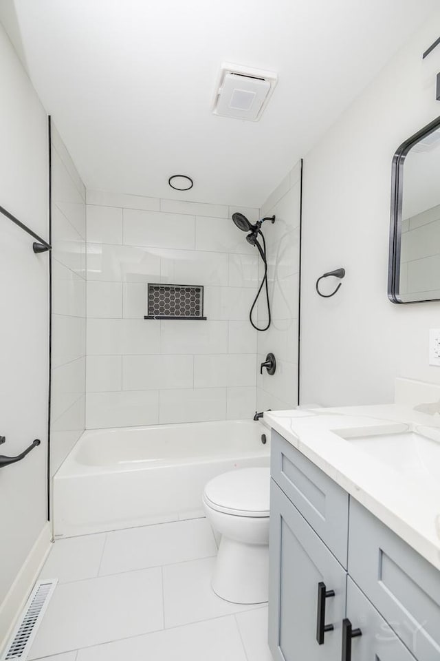 full bathroom with tile patterned flooring, vanity, toilet, and tiled shower / bath