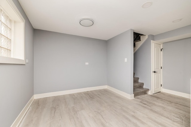 basement with light hardwood / wood-style flooring