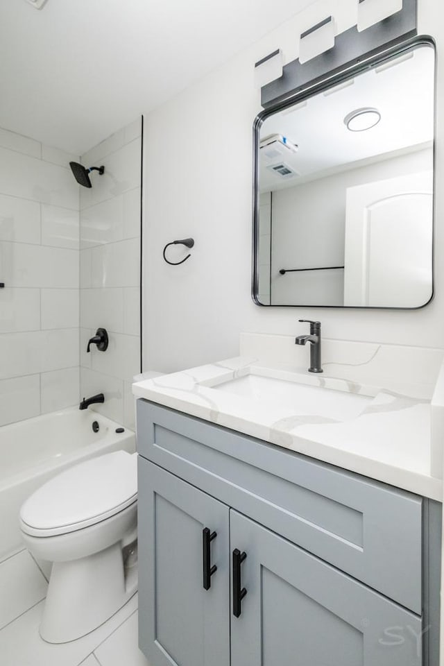 full bathroom with tiled shower / bath combo, toilet, and vanity