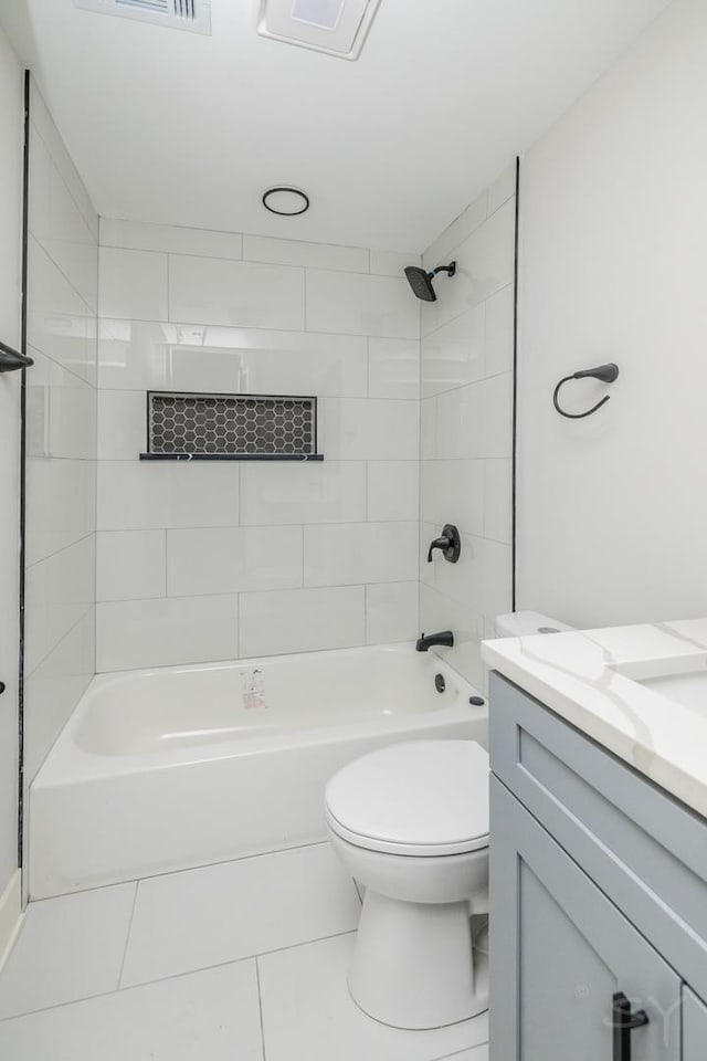 full bathroom with tile patterned flooring, vanity, toilet, and tiled shower / bath