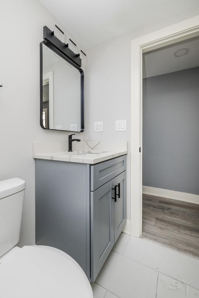 bathroom featuring tile patterned floors, vanity, and toilet